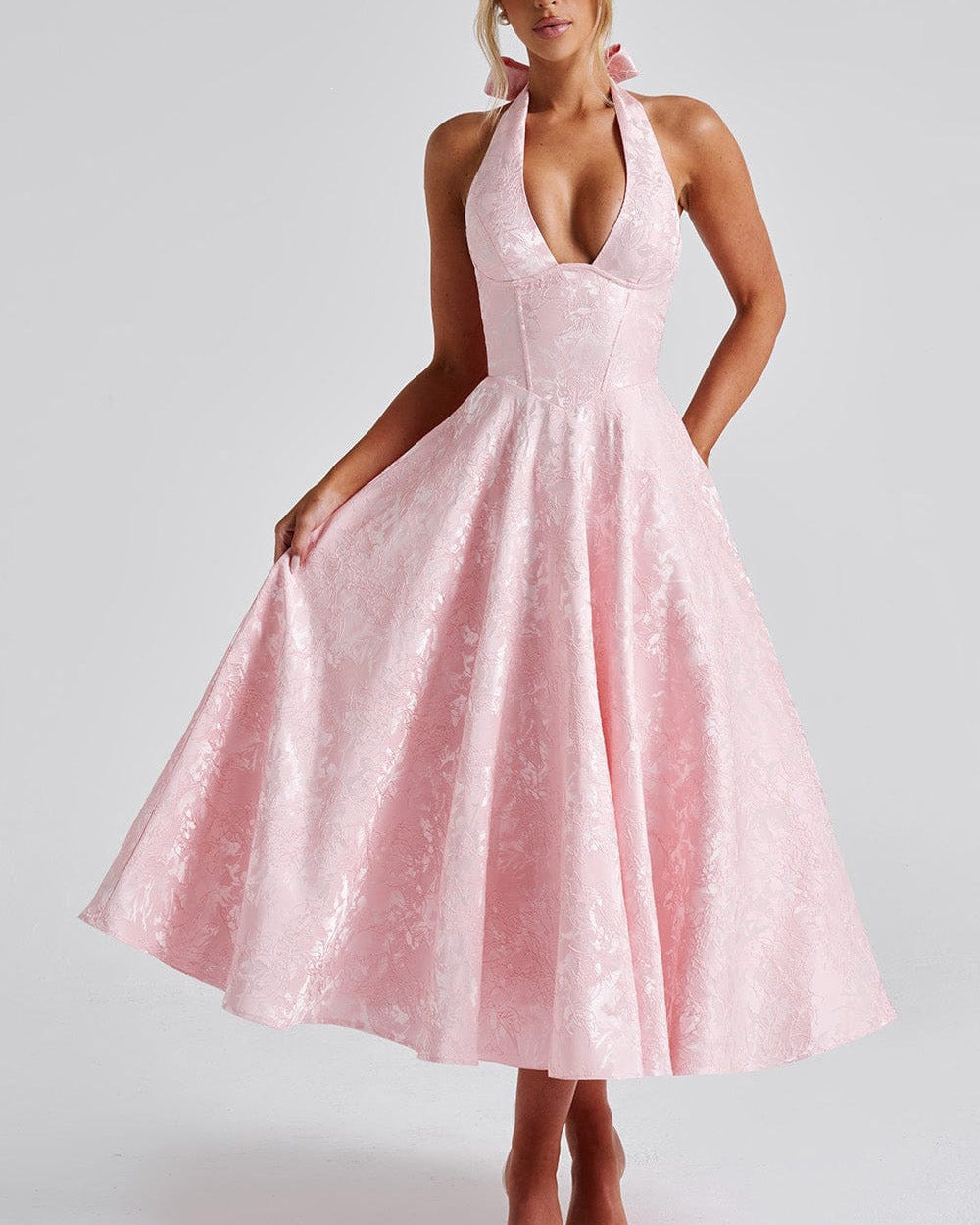 Woman wearing a pink dress on a white background