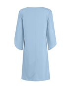 A light blue three-quarter sleeve dress shown from the back, featuring a simple crew neck and a central seam, set against a plain white background.