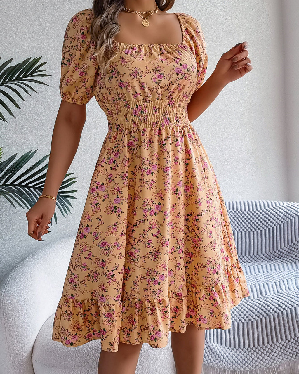 Woman wearing a floral dress in a home setting
