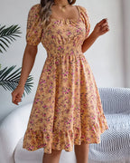 Woman wearing a floral dress in a home setting
