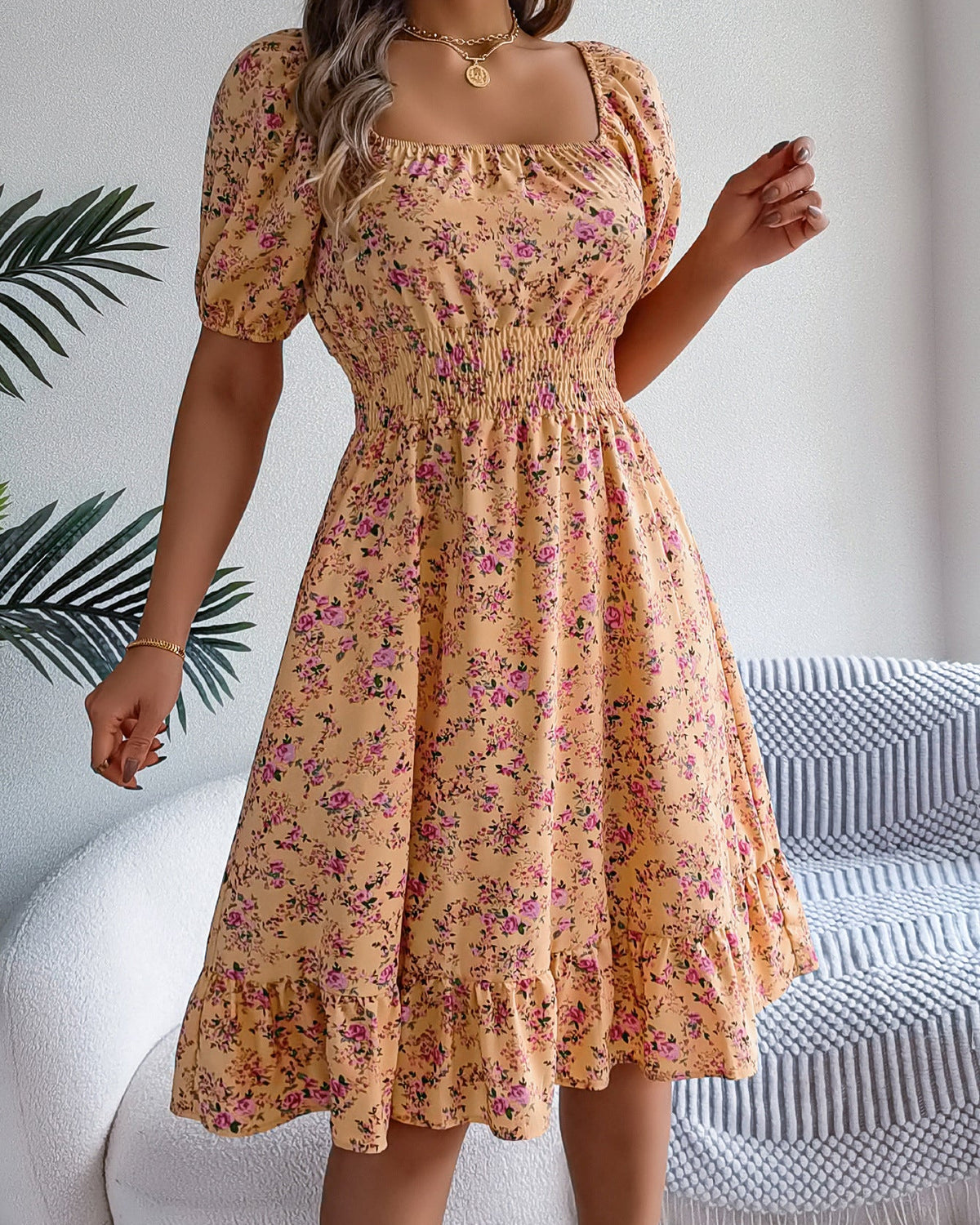 Woman wearing a floral dress in a home setting