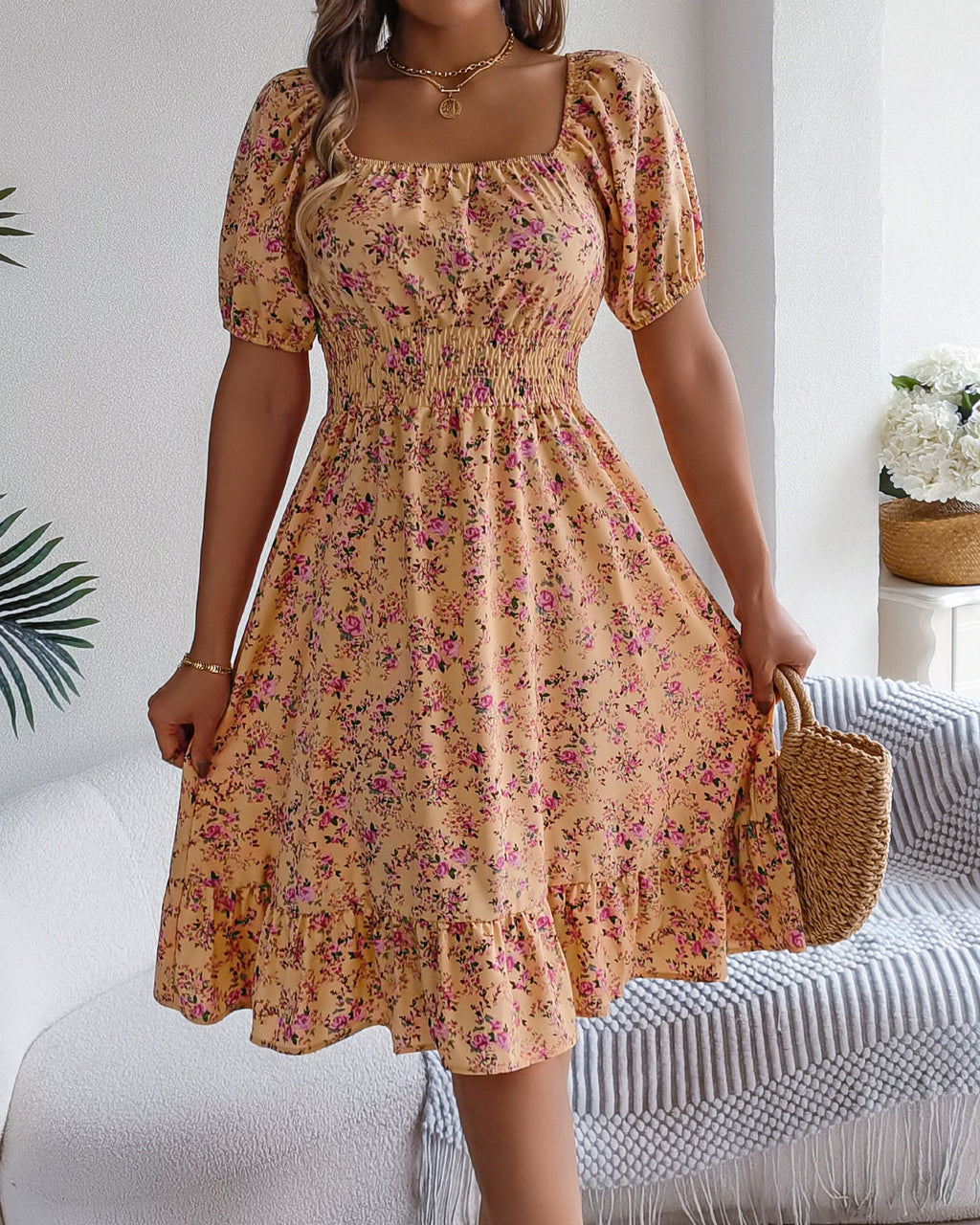 Woman wearing a floral dress in a home setting