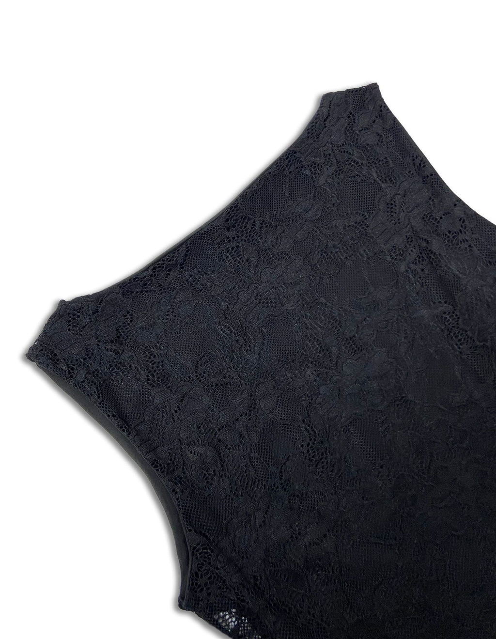 Close-up of a black lace garment, showing the detailed floral lace pattern and scalloped edge against a plain white background.