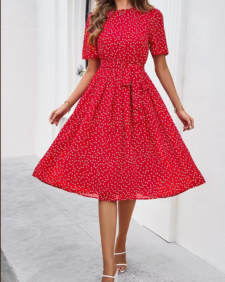 Red polka dot dress worn by a model on a white background