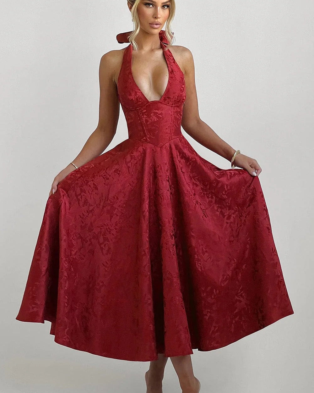 Woman wearing a red lace dress on a white background