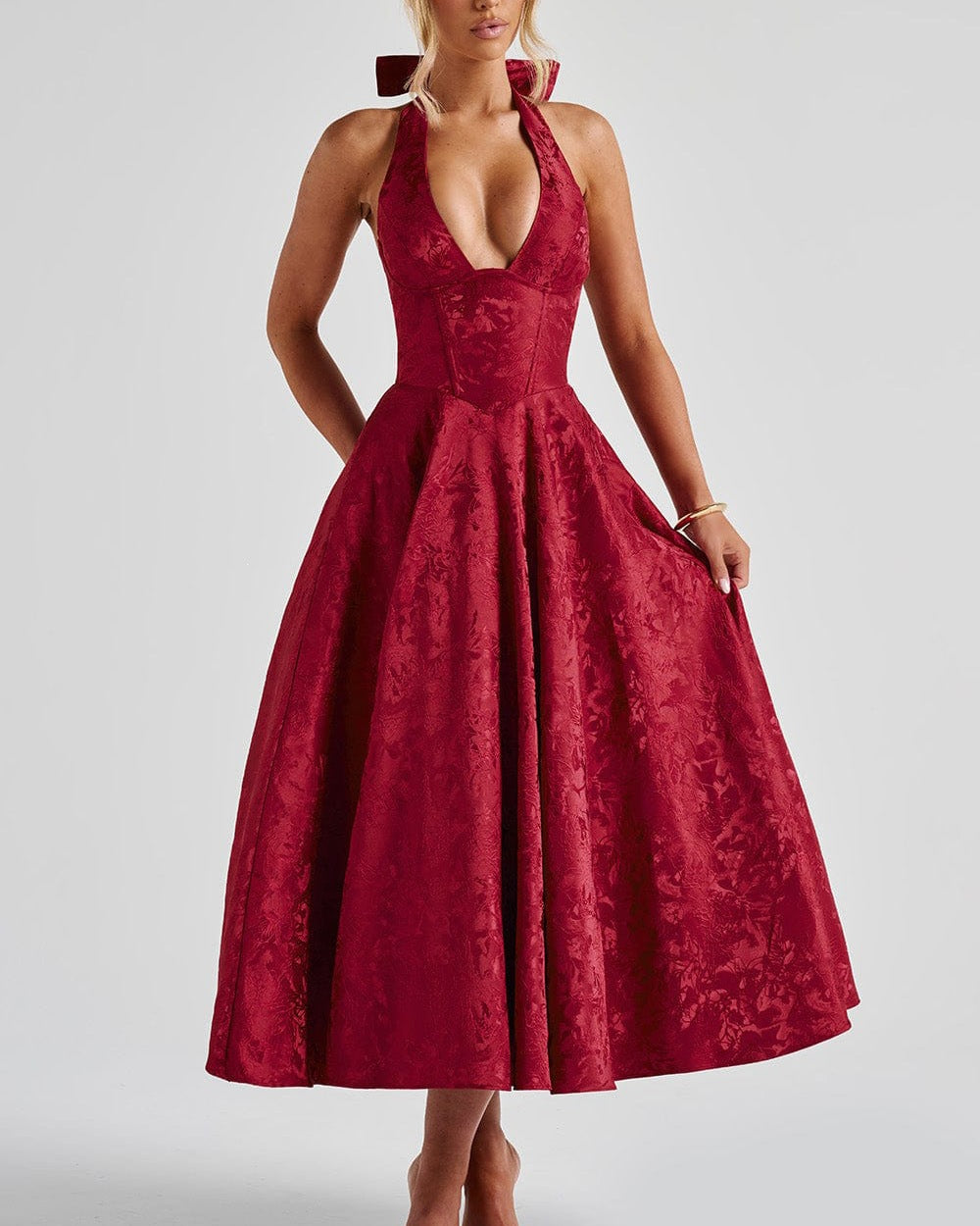 Red lace dress worn by a model on a white background