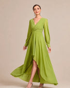 A woman modeling a long-sleeve, high-low midi dress in a vibrant lime green. The dress features a V-neckline with a twisted detail at the waist, gathered sleeves, and a flowing skirt with a high-low hemline.